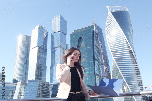 Businesswoman at skyscraper background