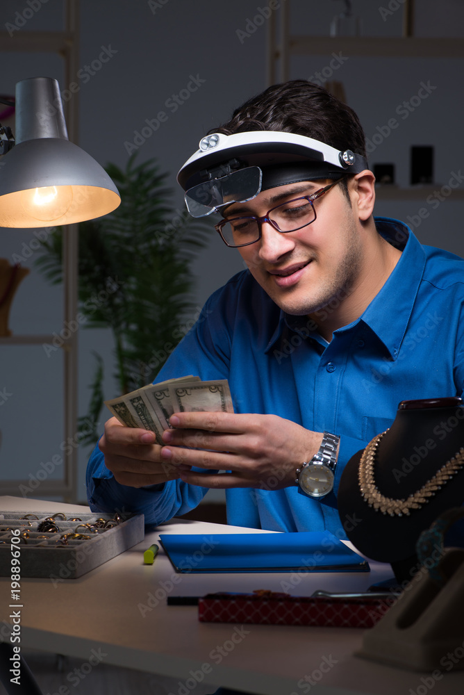 Jeweler working in his workshop late at night Jeweler working in his workshop late at night