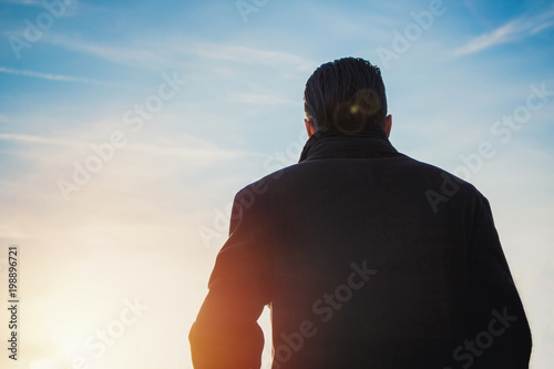 Back view of man against the sky.