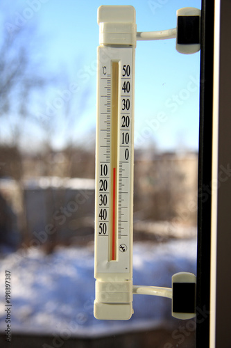 Thermometer on the window showing the temperature on the street.