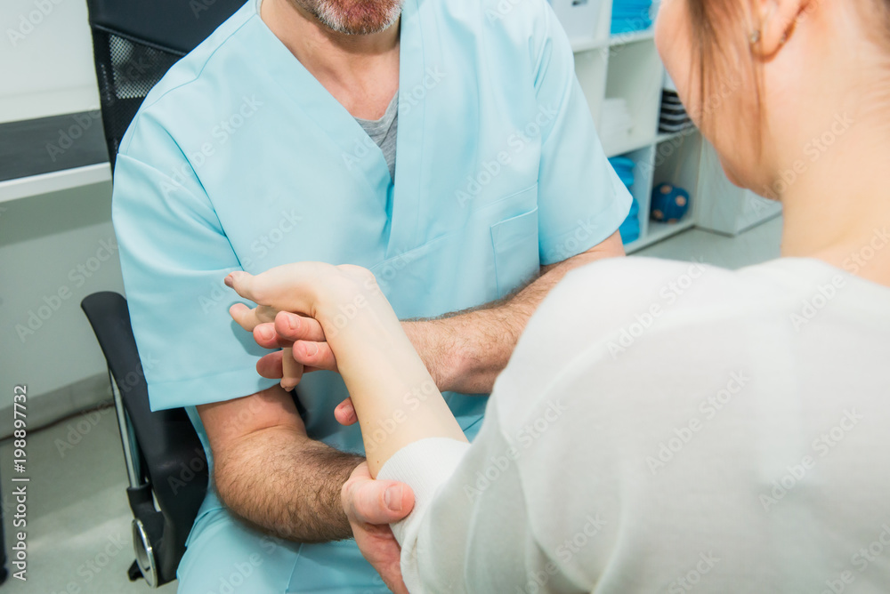 Neurological physical examination of the hands reflexes. Doctor neurologist checks the status of the patient's reflexes in office in hospital. Selective focus, space for text.