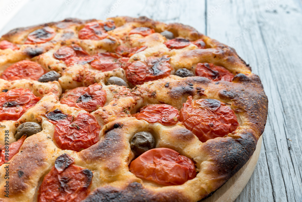 Focaccia typical of Bari Italy with tomatoes and olive