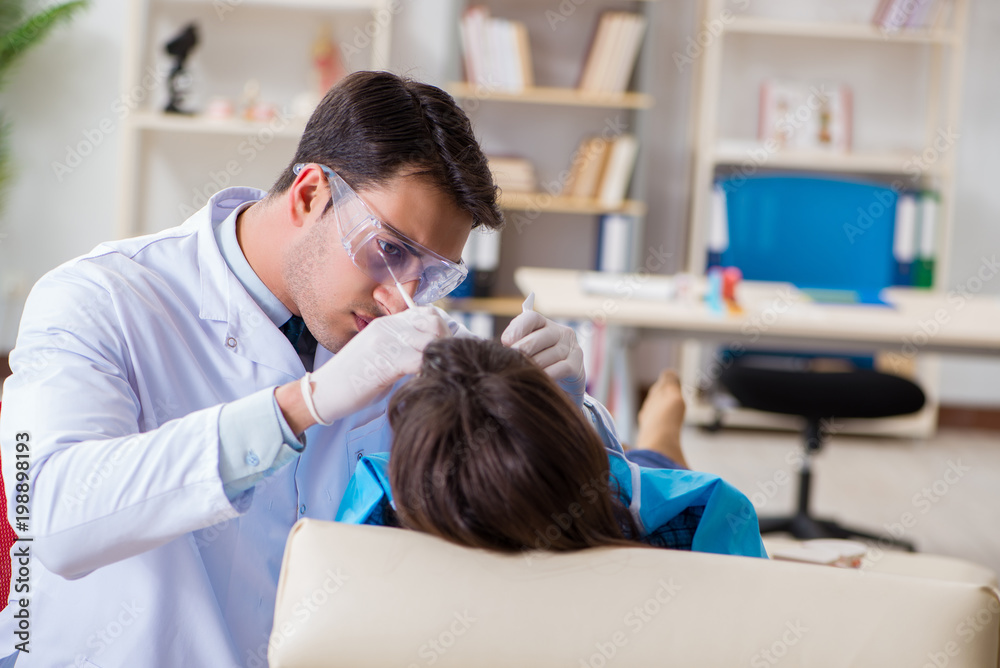 Patient visiting dentist for regular check-up and filling Patient visiting dentist for regular check-up and filling