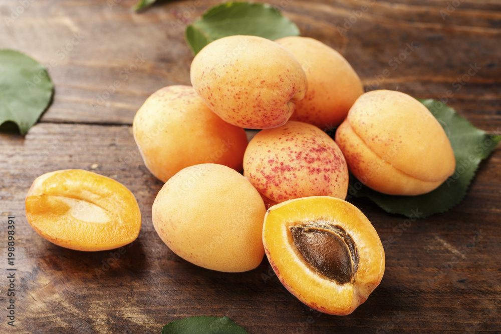 Apricot fruit. Fresh organic apricots on  wooden background.
