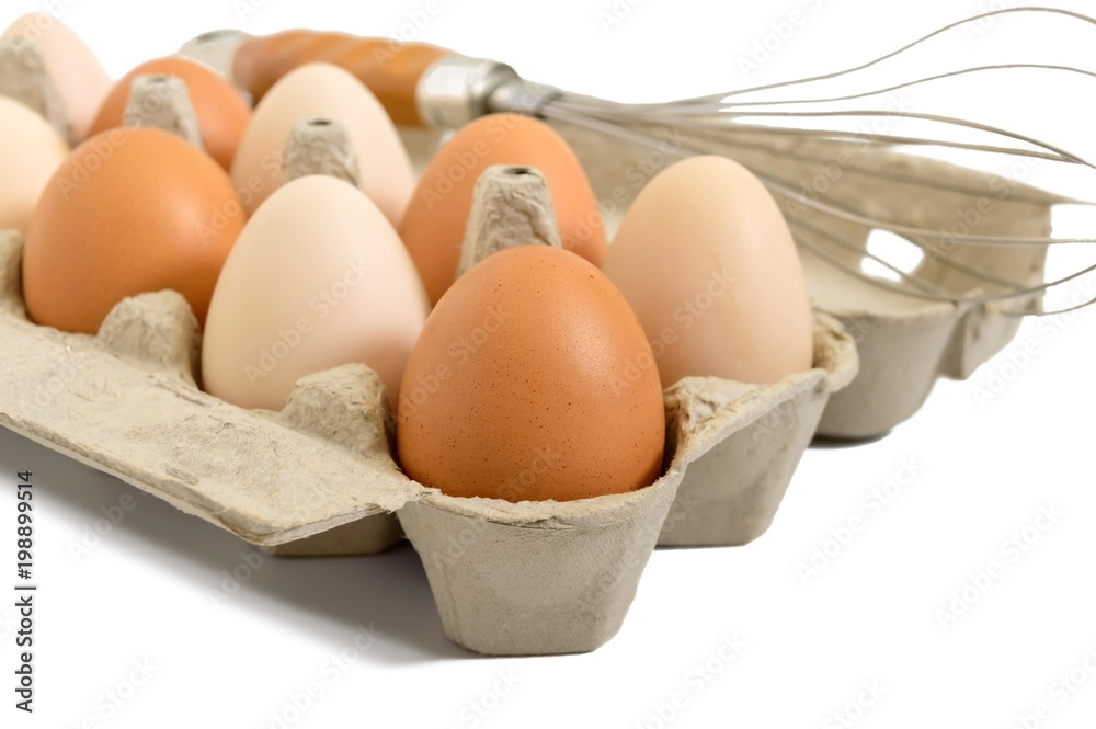 Fresh raw chicken eggs in carton box, isolated on white background. Close-up on brown and white eggs. The main ingredient for many dishes. Fresh raw chicken eggs in carton box, isolated on white background. Close-up on brown and white eggs. The main ingredient for many dishes.