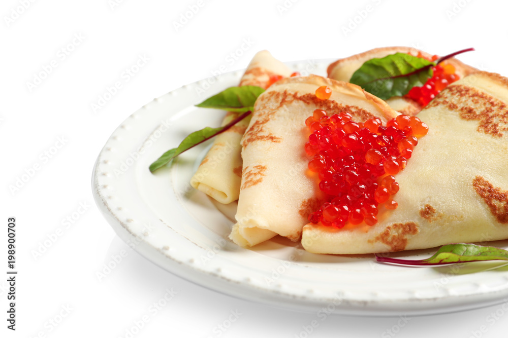 Thin pancakes with red caviar on plate against white background Thin pancakes with red caviar on plate against white background