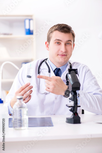 Male doctor looking at lab results in hospital