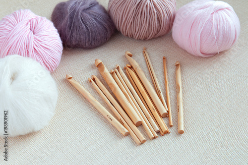 Wooden crochet hooks with balls of yarn pastel colors. Hoppy concept.