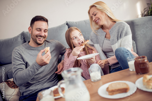 Family of three having breakfast in the morning together