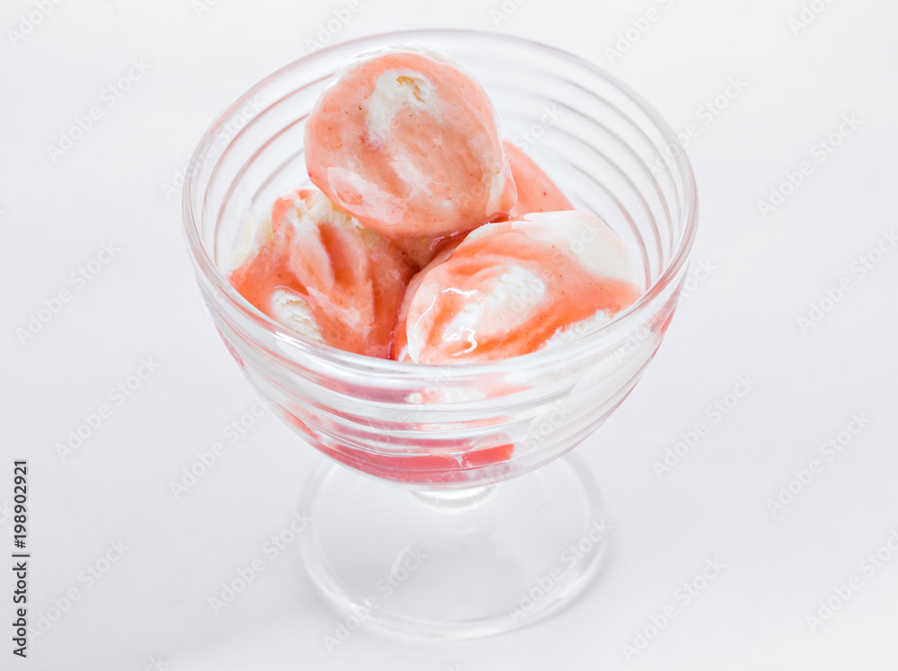 Vanilla ice cream with strawberry syrup on white background. Scoops of vanilla ice cream in glasses bowl. Vanilla ice cream with strawberry syrup on white background. Scoops of vanilla ice cream in glasses bowl.