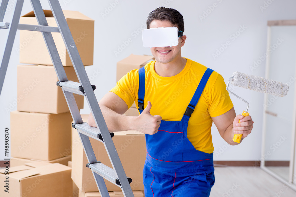 Painter contractor working with virtual reality goggles Painter contractor working with virtual reality goggles