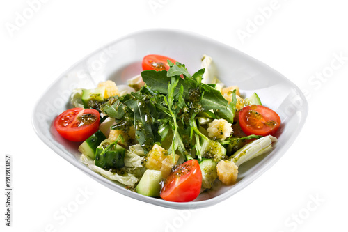 Greek salad. Vegetable with arugula leaves, green salad, with cherry tomatoes, fetta cheese, red onion, and mixed greens