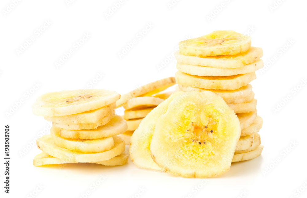Dried banana chips snack stacked over white Dried banana chips snack stacked over white