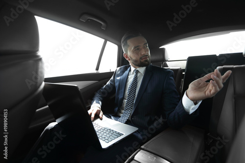 Confident businessman talking in car © ASDF