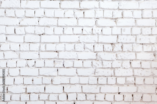 White brick wall background. Texture of a stone wall. Brick wall dyed in white color