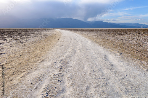 Salt Trail - A white salt footpath winding through vast salt flats of Badwater Basin at base of Panamint Range. Death Valley National Park  California  USA.