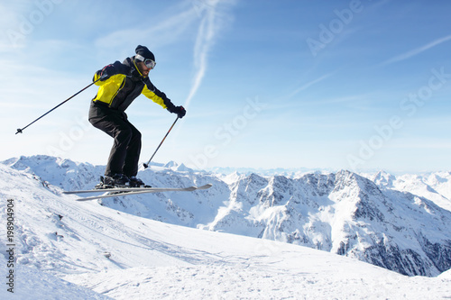 Jumping skier at mountains