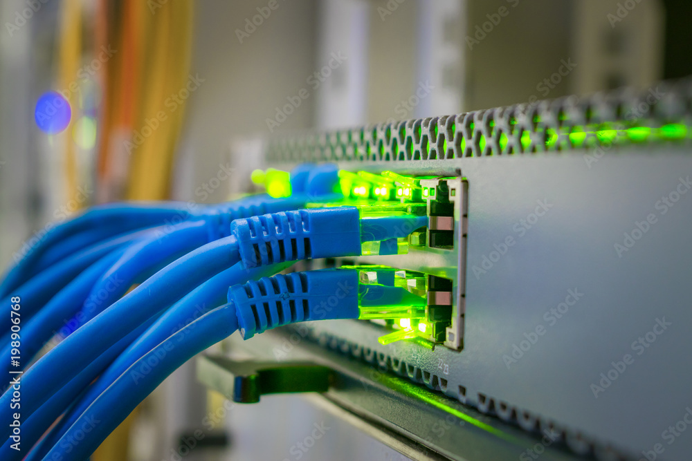 Bunch of patchcords are connected to a managed switch. Internet connection. Network wires are included in the ports of the central router. Selective focus Bunch of patchcords are connected to a managed switch. Internet connection. Network wires are included in the ports of the central router. Selective focus