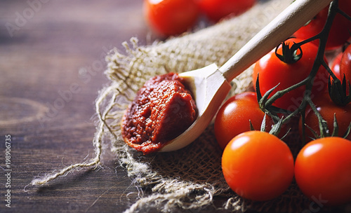 Branch with fresh cherry tomatoes. Ripe red tomatoes. photo