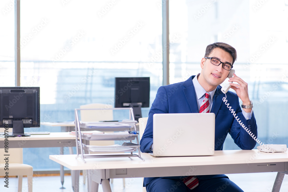 Businessman talking on the phone in the office Businessman talking on the phone in the office