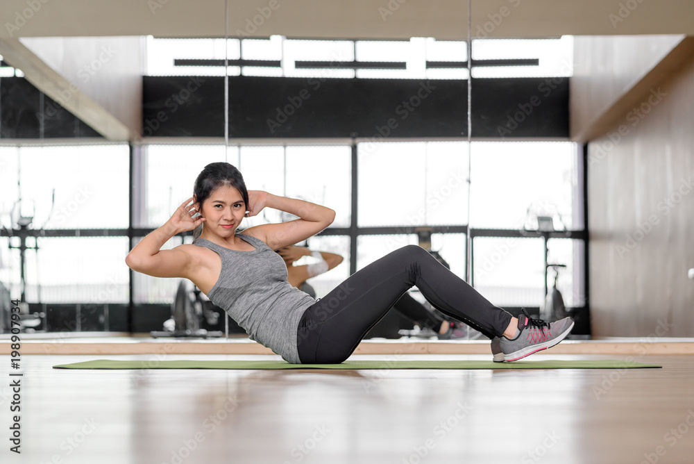 Asian woman doing abs crunches exercise