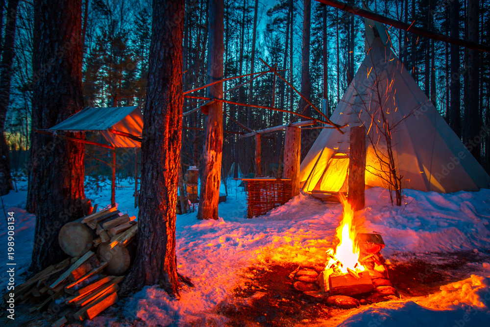 Tipi in the snow-covered forest. Indian parking. The bonfire burns at the  entrance to the Wigwam. The home of the Indians of Tipi. Wigwam in winter.  Stock Photo | Adobe Stock