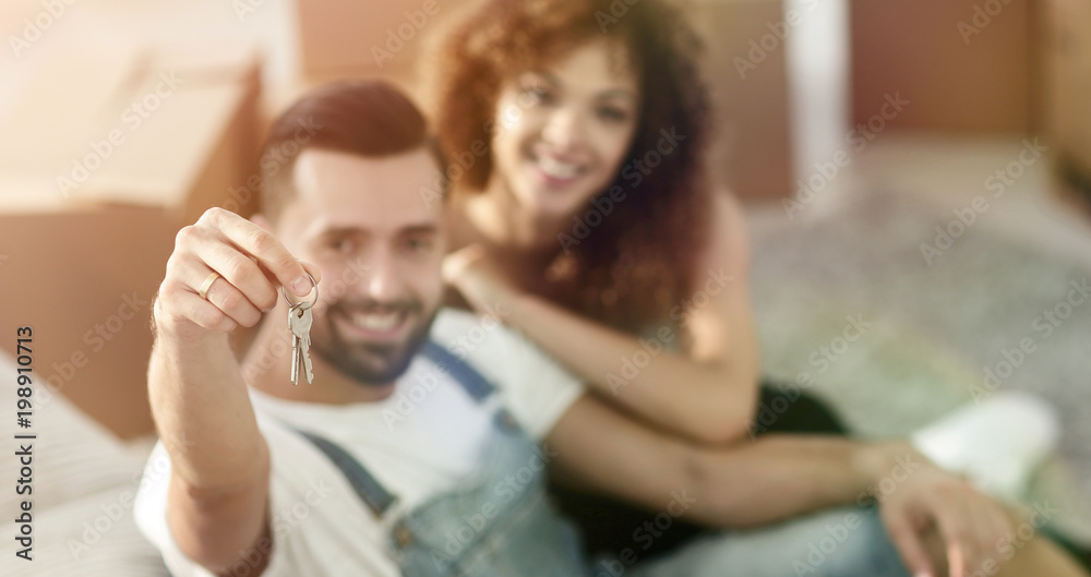 Young couple with a key to a new apartment. Young couple with a key to a new apartment.