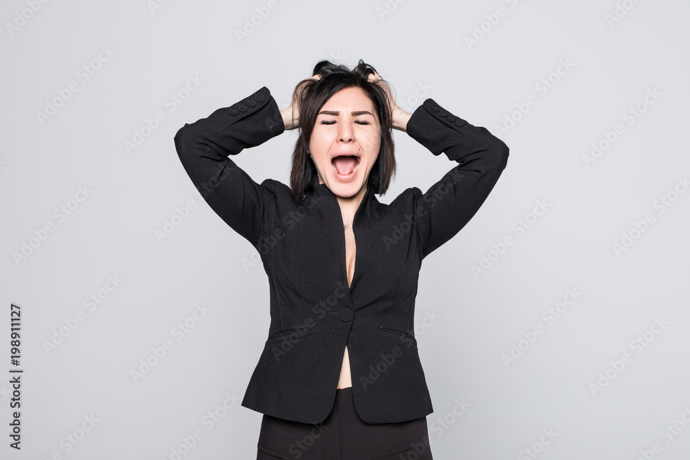 Stress. Woman stressed is going crazy pulling her hair in frustration. Close-up of young businesswoman on white background Stress. Woman stressed is going crazy pulling her hair in frustration. Close-up of young businesswoman on white background