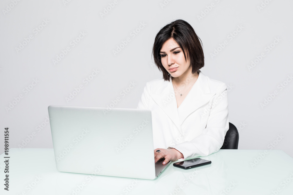Business woman sitting with a laptop, isolated on white background Business woman sitting with a laptop, isolated on white background