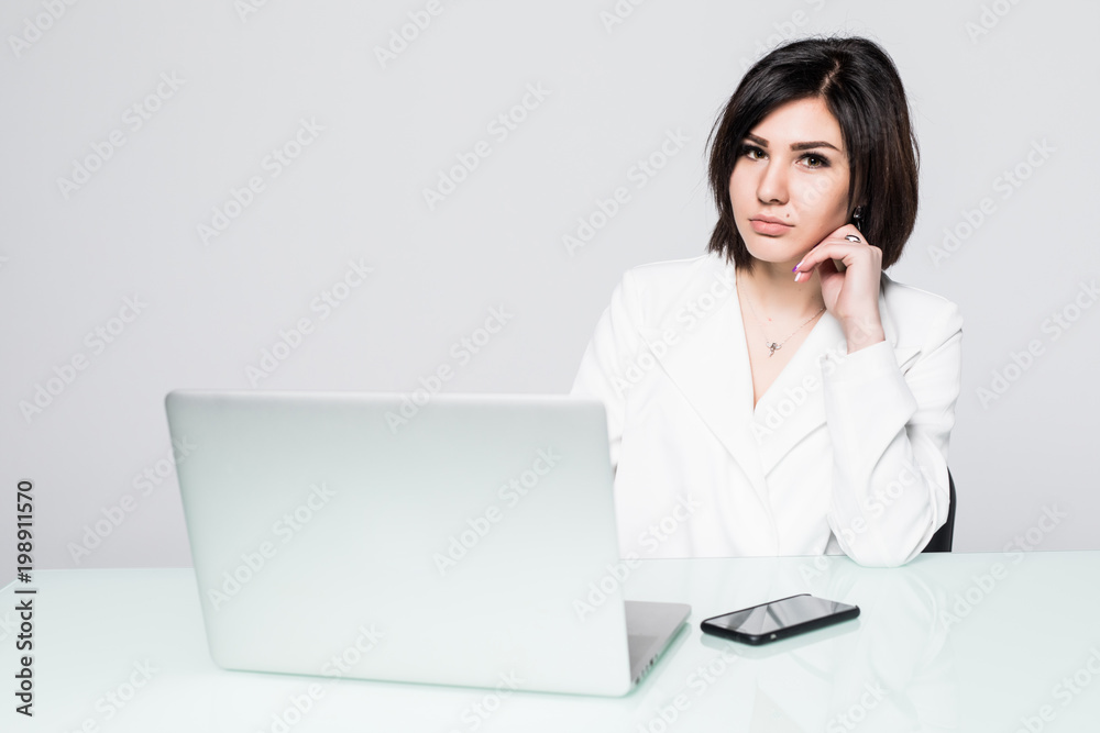 Business woman sitting with a laptop, isolated on white background Business woman sitting with a laptop, isolated on white background