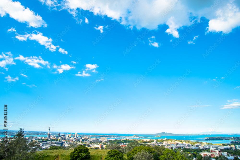 Landscape of Auckland City, New Zealand with the sea, tower, blue sky and cloud.  View from Mt. Eden