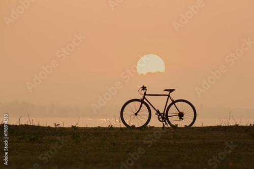 silhouette bicycle with sunset or sunrise background