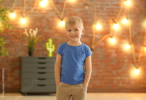Cute little boy against blu...