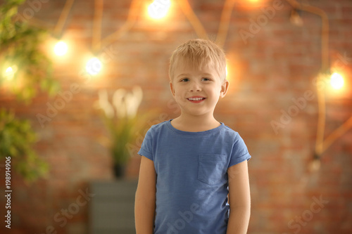 Cute little boy against blu...