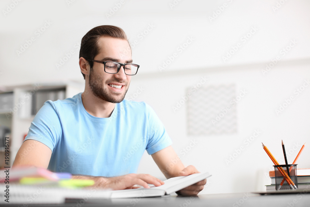 Student studying at table indoors Student studying at table indoors