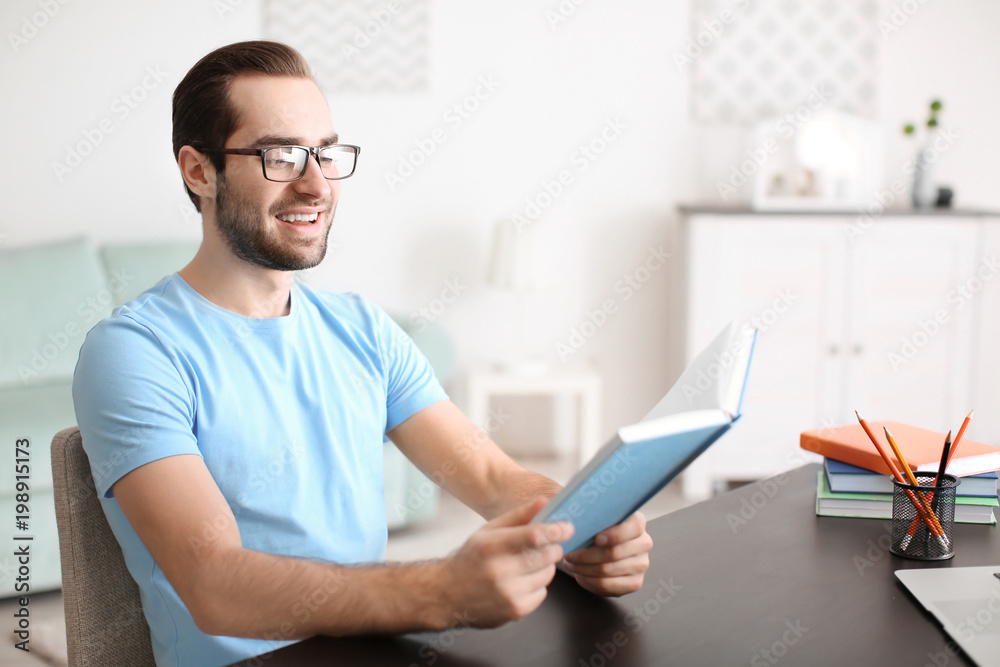 Student studying at table indoors Student studying at table indoors