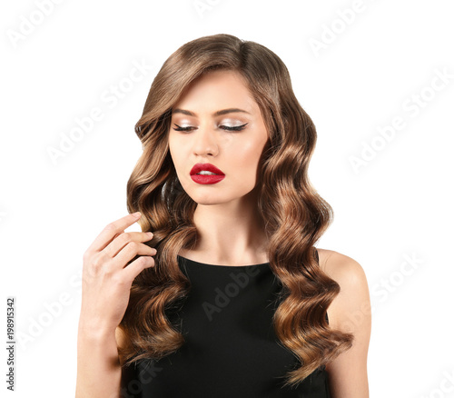 Beautiful young woman with long wavy hair on white background