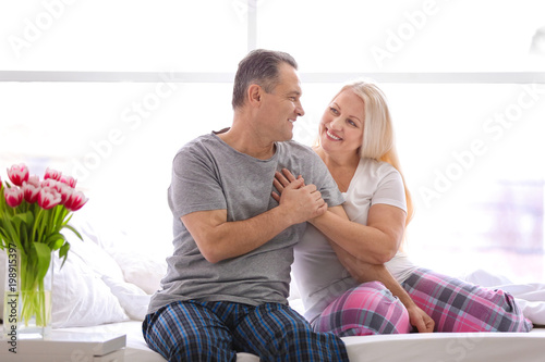 Senior couple on bed togeth...