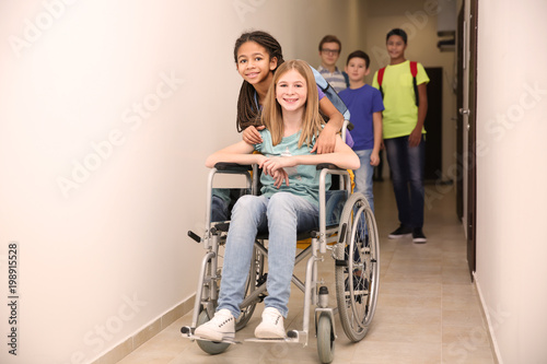 Classmate helping girl in w...