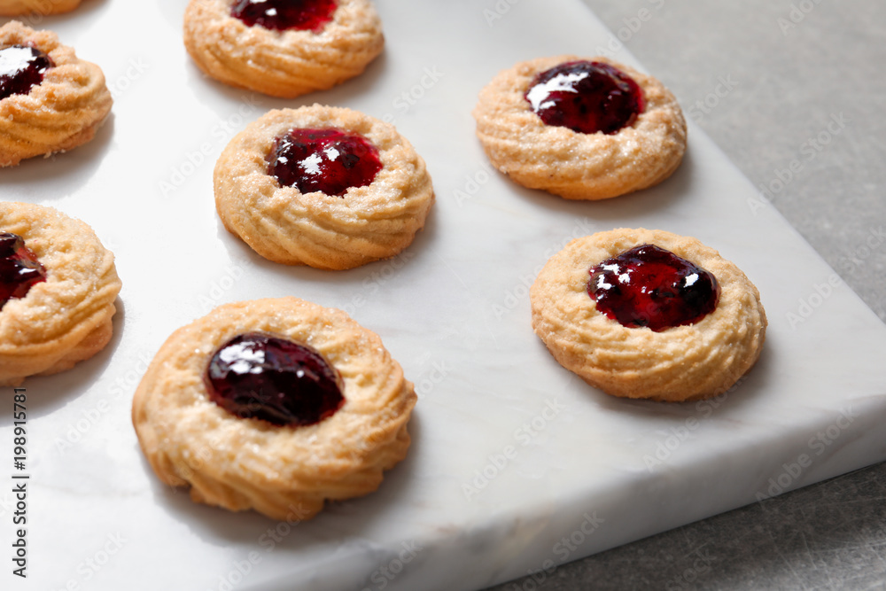Tasty cookies with jam on stone board Tasty cookies with jam on stone board