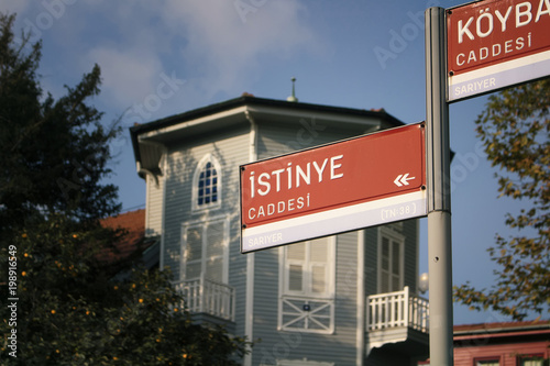 Street signs (ICaddesi means Avenue) with old, wooden, historical house in Istanbul.