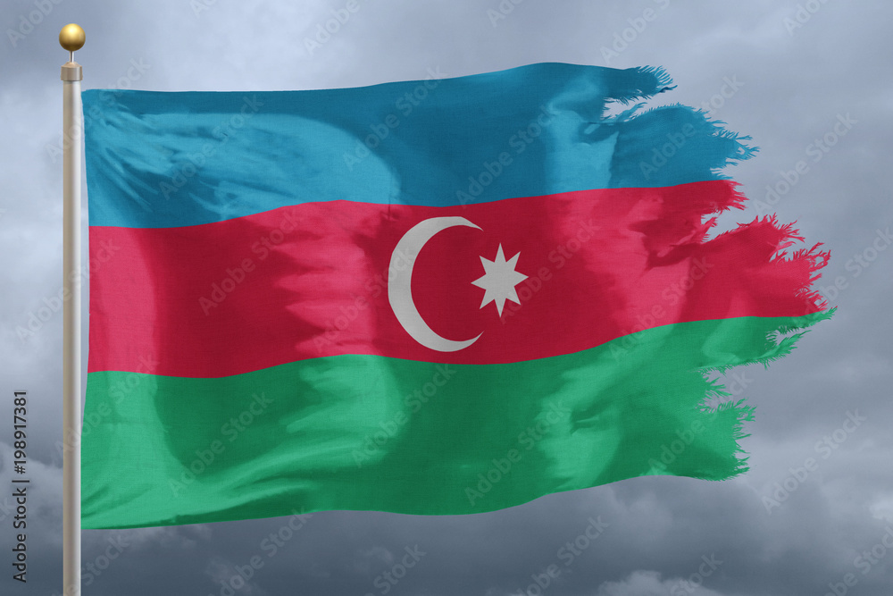 Azerbaijan Flag with torn edges in front of a stormy sky
