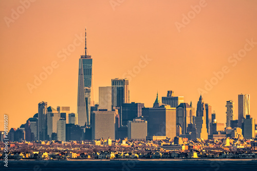 New York highrise skyline with lowrise Brooklyn borough in the foreground, as viewed at sunrise, from Sandy Hook, NJ.