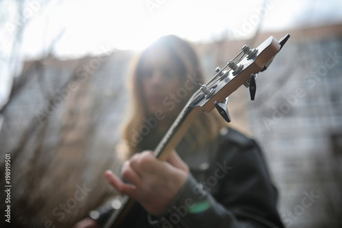 Rock guitarist on the steps. A musician with a bass guitar in a 