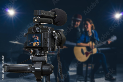 Professional digital Mirrorless camera with microphone recording video blog of Musician duo band singing a song and playing music instrument,Camera for photographer or Video and Live Streaming concept