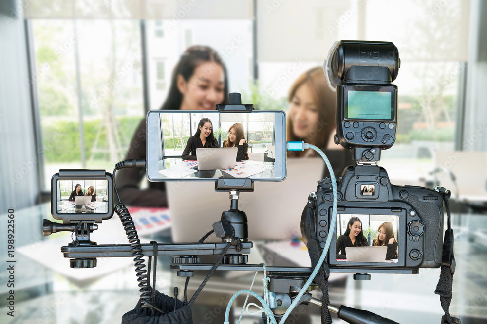Professional set of camera with smart mobile phone and action camera on  tripod over Two Asian young Businesswoman giving the interview via Live  stream, Live Streaming for entrepreneur concept foto de Stock