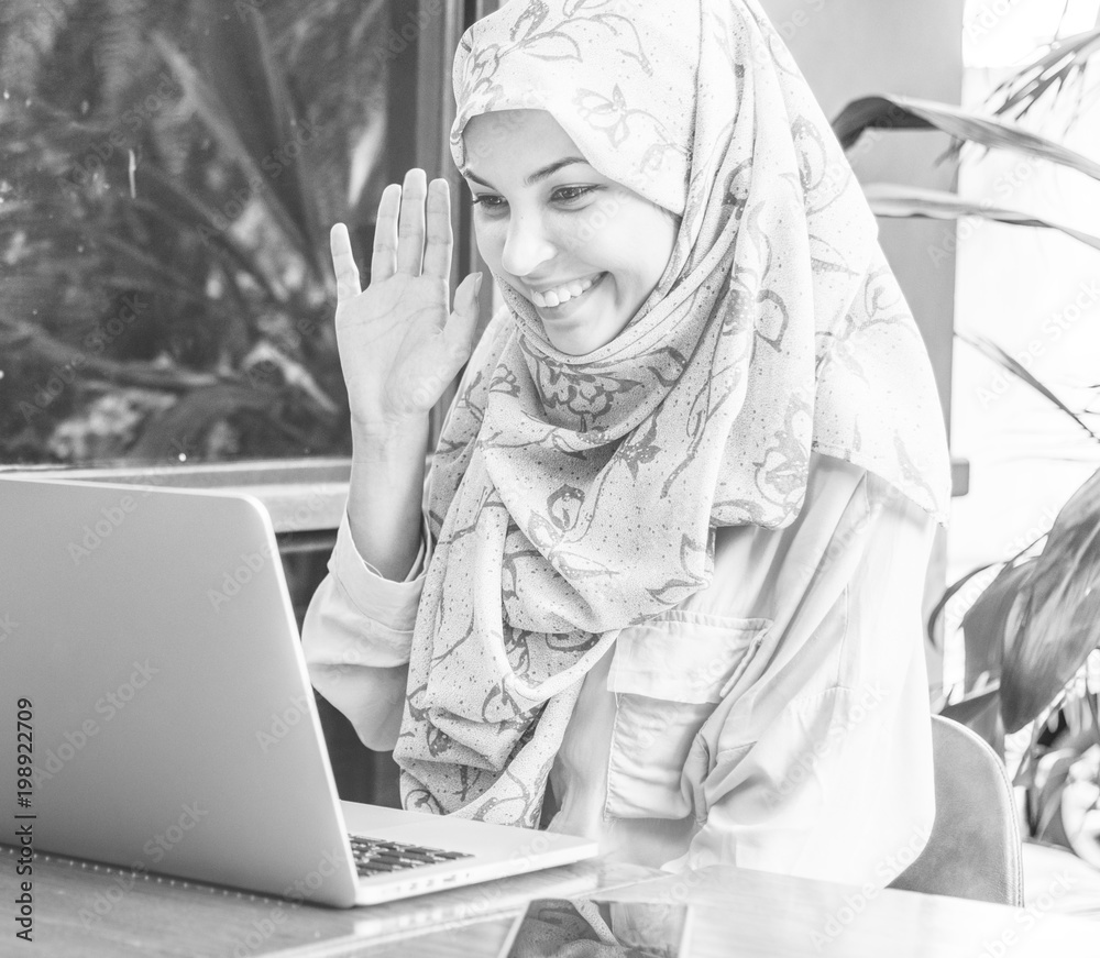 Islamic woman using laptop foe video call with happy face Islamic woman using laptop foe video call with happy face