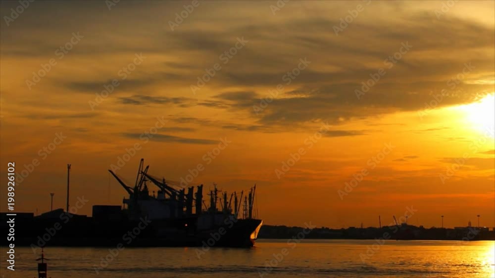 Time Lapse - Shipping through sea ports and sea view in the evening , Sunset shines with water reflection Time Lapse - Shipping through sea ports and sea view in the evening , Sunset shines with water reflection