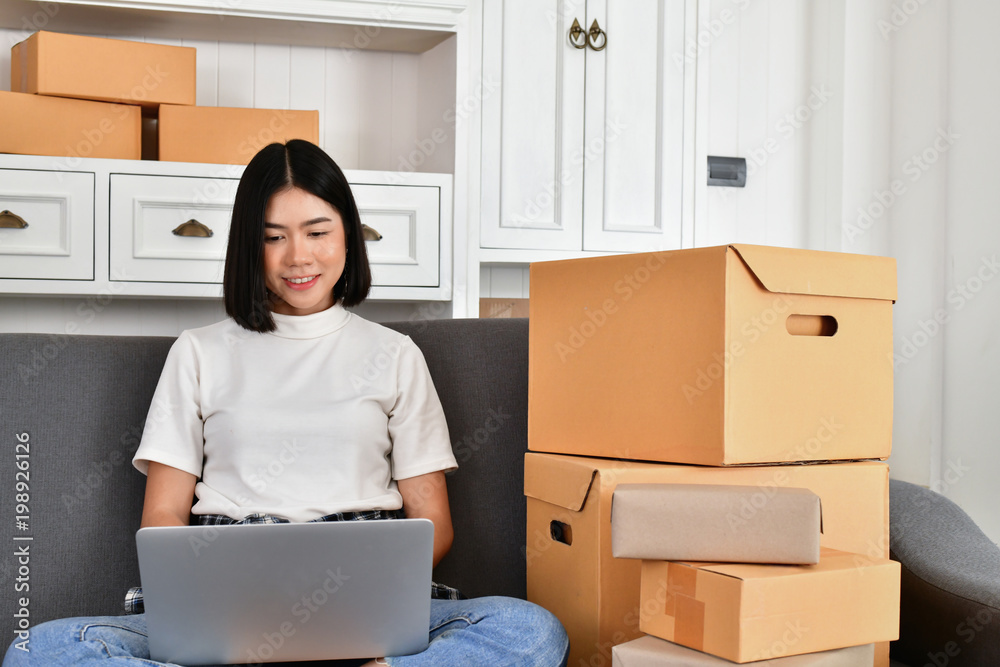 Sme business concept. Young Asian people are packing their packages.Delivery business Small and Medium Enterprise (SMEs). Young man is working in the house.Young Owner Start up for Business Online. Sme business concept. Young Asian people are packing their packages.Delivery business Small and Medium Enterprise (SMEs). Young man is working in the house.Young Owner Start up for Business Online.