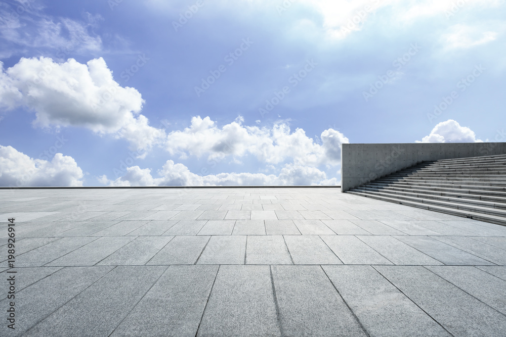 empty square floor and blue sky with white clouds in the daytime